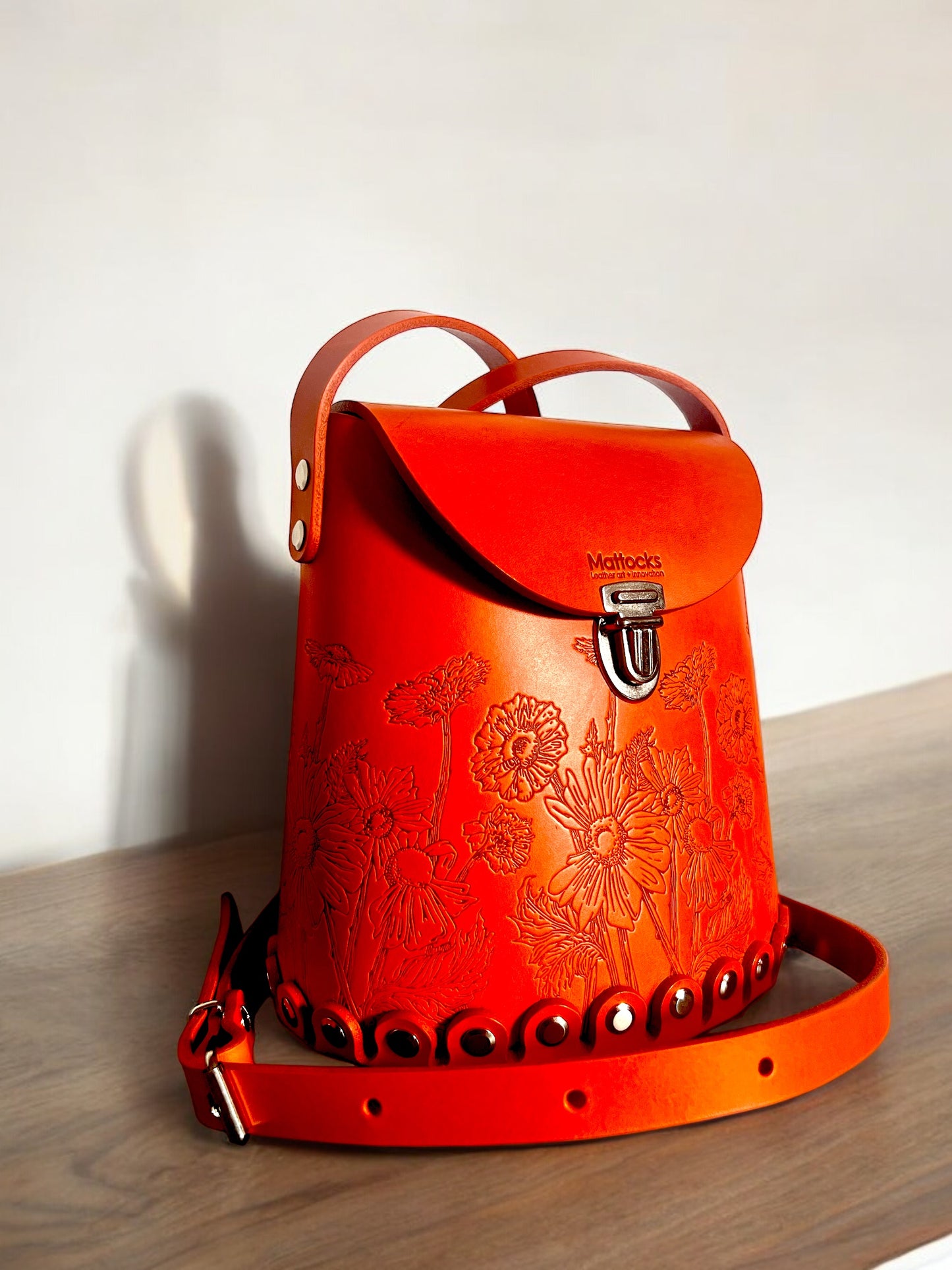 Orange leather bucket bag with “Wild Woods” original artwork