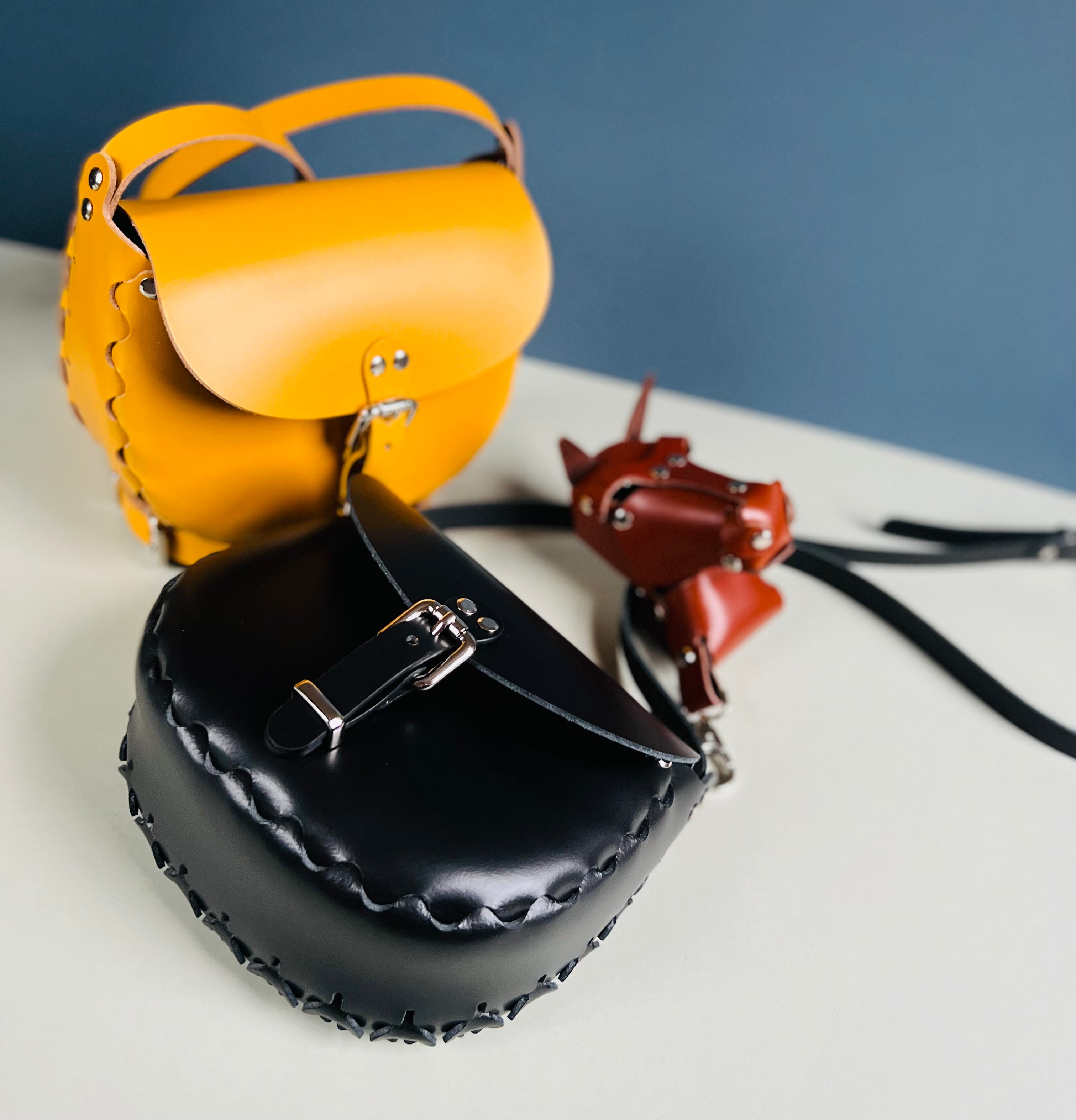 Handmade  leather saddle bags and accessories crafted in tan leather and silver chrome hardware. Limited edition innovative designs inspired by contemporary art and classic vintage styles. Saddle bags handmade in Nottingham. 