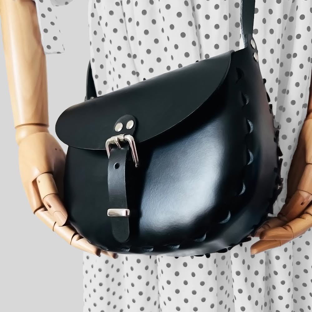 Handmade  leather saddle bags and accessories crafted in tan leather and silver chrome hardware. Limited edition innovative designs inspired by contemporary art and classic vintage styles. Saddle bags handmade in Nottingham. 