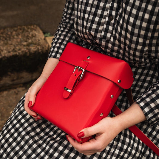 Red leather box bags, satchels and accessories. All handmade responsibly in vegetable tanned red leather and quality silver hardware. Limited edition and sustainable while inspired by classic fashion vintage fashion styles and modern art. 