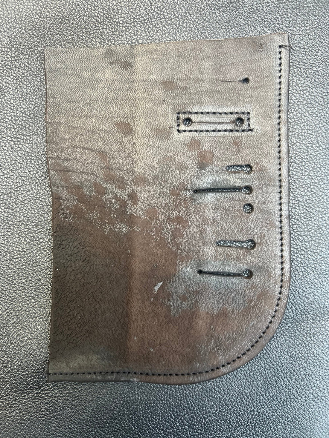 Leather research sample showing surface variations, stitching and constructed details