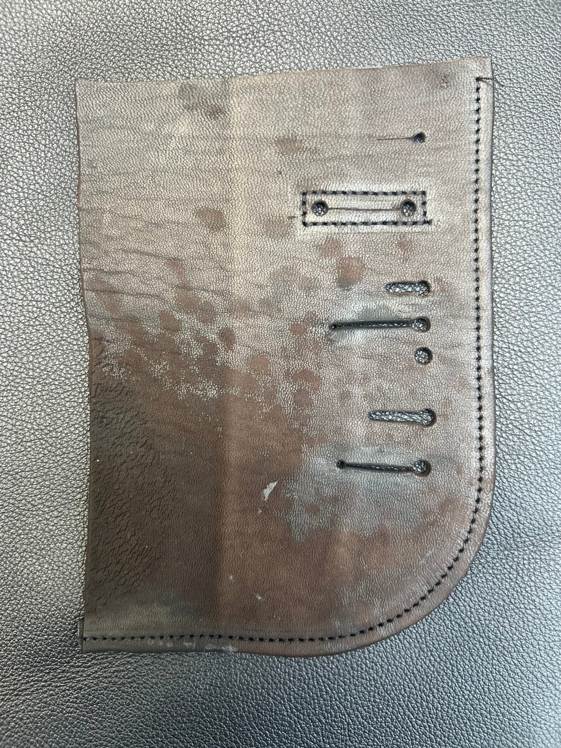 Leather research sample showing surface variations, stitching and constructed details
